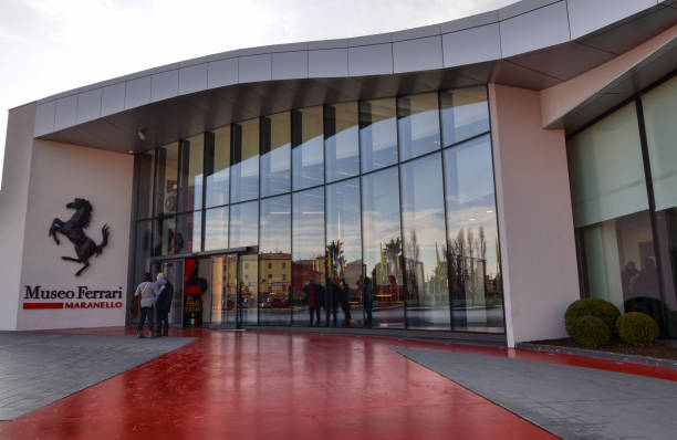 Maranello, Italy, December 2018. Entrance to the Ferrari museum, The black prancing horse leaves no doubt: we are in the home of engines. People stop for a souvenir photo.